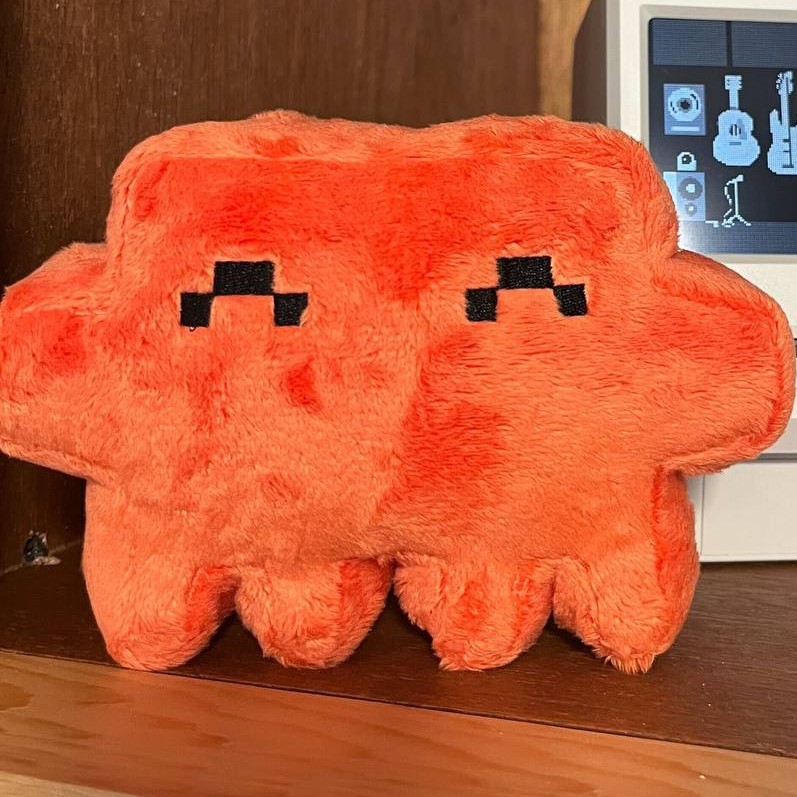 REPLACE: Close-up photo of the official orange Anthropic Clawd plush toy.
